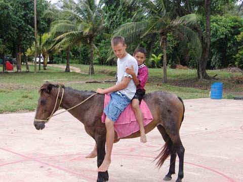 Joel Schuler taking the kids for a ride on his horse